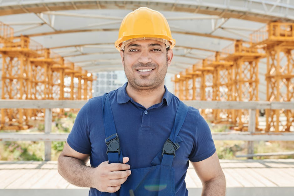 Friendly construction worker reviewing home exterior plans